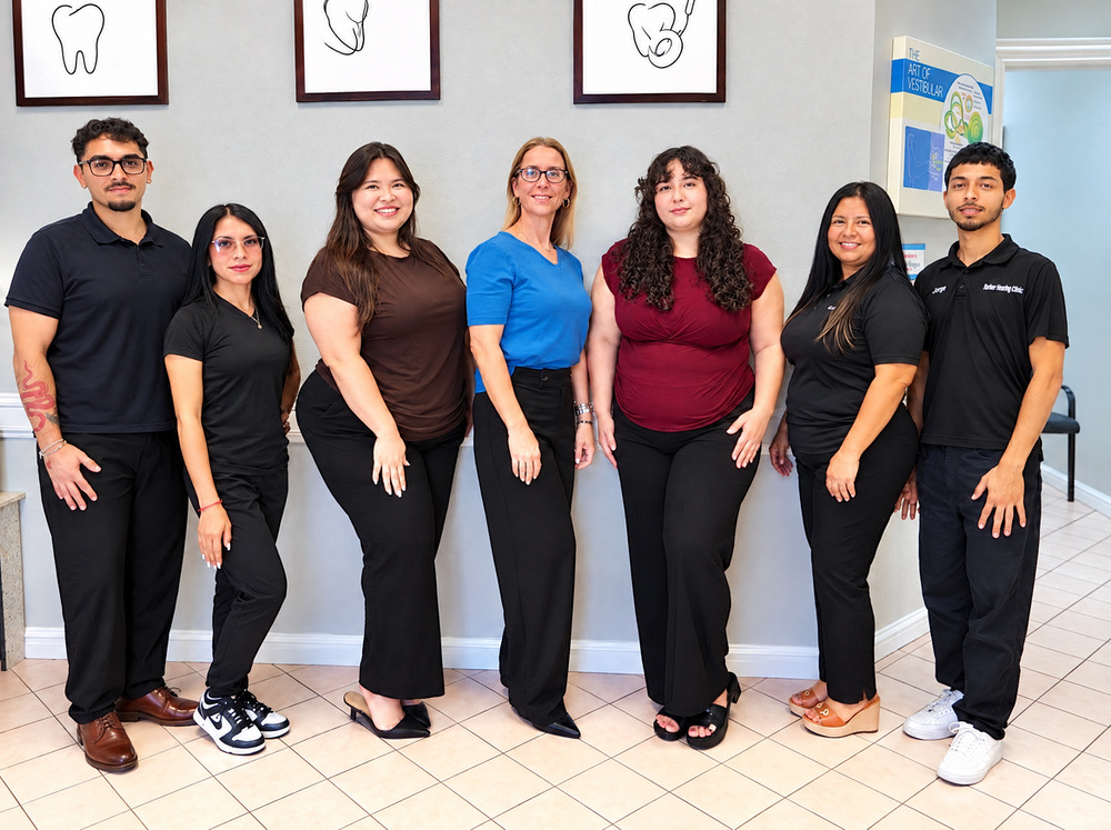 The Better Hearing Clinic team of audiologists and hearing care staff in the clinic lobby in McAllen, TX