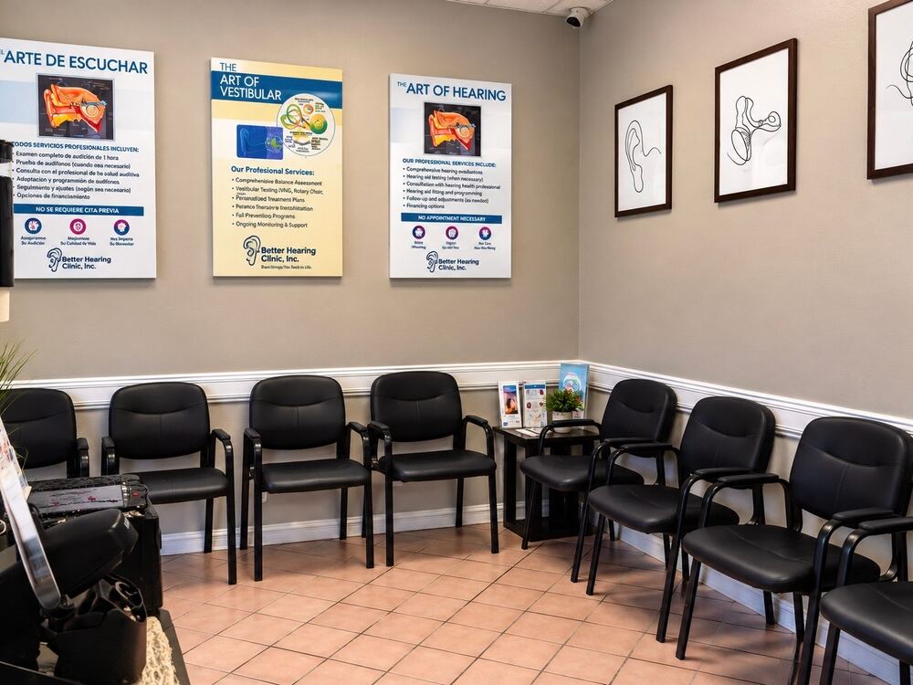 Patient waiting room with bilingual hearing and vestibular service posters at Better Hearing Clinic in McAllen, TX